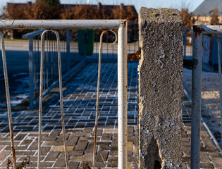 Weathered metal and stone create an intriguing contrast in a forgotten urban landscape at dusk