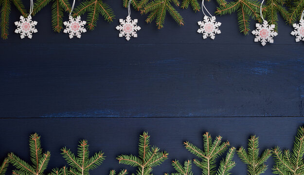 Wooden Christmas background with fir branches and snowflakes on blue background - Powered by Adobe