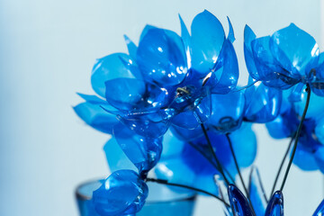 Beautiful blue flowers made from recycled materials create an extraordinary artistic display in a modern setting