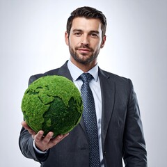 Businessman holding a green globe, symbolizing environmental responsibility and sustainability.