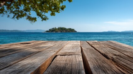 Fototapeta premium A serene view from a rustic wooden deck looking out to a tropical island in the azure sea. The gentle waves and clear blue sky create a tranquil atmosphere perfect for relaxation.