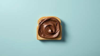 Chocolate spread layered on bread against a bright blue backdrop, suitable for menu design or recipe presentation, National Chocolate Day