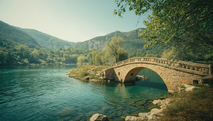 Old Kouiassa stone bridge crossing a flowing river in a mountainous region, emphasizing preservation efforts