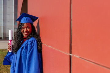 Black student celebrating graduation with a certified diploma, wearing cap and gown