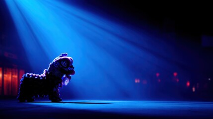 A small lion puppet stands on a dim stage under a blue spotlight, creating a mystic and evocative performance