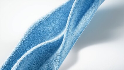 Fototapeta premium Home cleaning microfiber cloth in blue on textured canvas, focused on surface care practices
