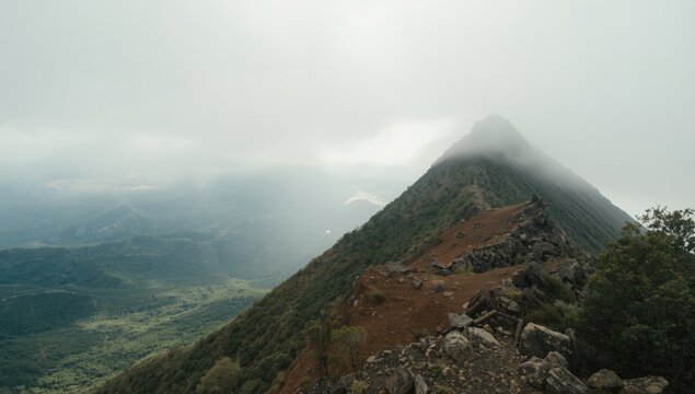 Snow-capped mountain peak in Gran Canaria under overcast skies with diffused sunlight, highlighting winter conditions - Powered by Adobe