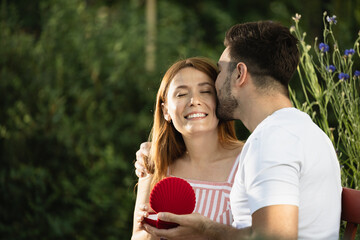 Surprising moment in park with happy couple celebrating love