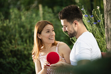 Surprising moment in park with happy couple celebrating love