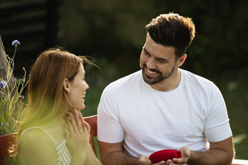 Surprising moment in park with happy couple celebrating love