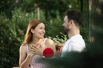 Surprising moment in park with happy couple celebrating love