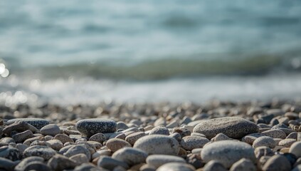 Seashore with grey and white stones, serving as a calming meditation setting in daylight, featuring round pebbles and cobblestones during summer