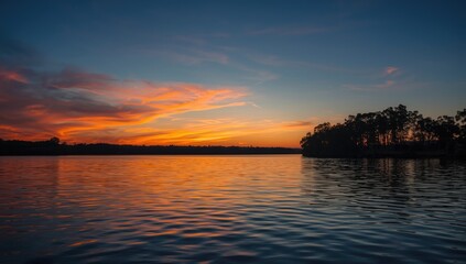 Naklejka premium Sunset scene with water and trees emphasizing nature's beauty for summer outdoor activities, Earth Day