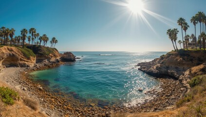 Fototapeta premium Seaside view at La Jolla Cove featuring rocky cliffs, tide pools, palm trees, and bright blue skies, emphasizing erosion risk
