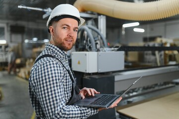 Carpenter programming cnc machine in furniture factory