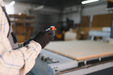 Furniture maker operating cnc machine in a sofa factory