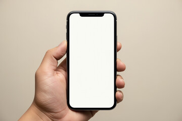 Hand holding smartphone with blank white screen, neutral background