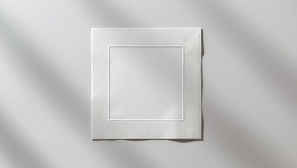 Embossed square pattern on white textured paper serving as a background for layout or text placement