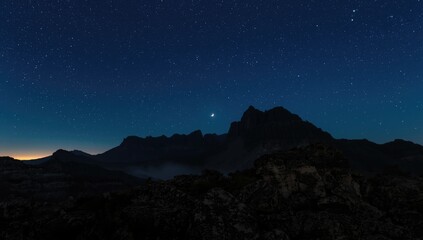 Nighttime mountain scene in Montserrat showing rocky slopes and starry sky, ideal for layout backdrop