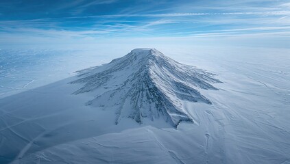 Top-down perspective of a wild mountain blanketed in snow, highlighting texture and wilderness