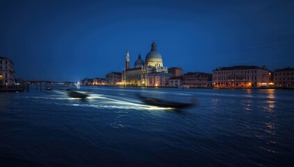 Naklejka premium San Giorgio Maggiore church during blue hour with gondolas and illuminated boats in San Marco Square, Venice evening scene