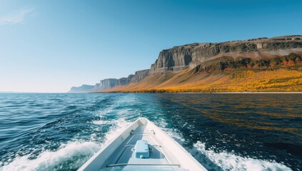 Autumn scenery along the Barents Sea coast viewed from a boat, highlighting seasonal transition in Arctic regions