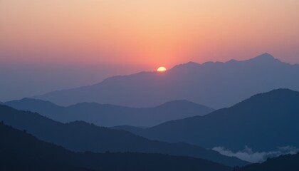 Fototapeta premium Sunset over mountain landscape with vibrant orange and purple hues