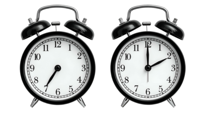 Two classic black alarm clocks showing different times on a white face, isolated