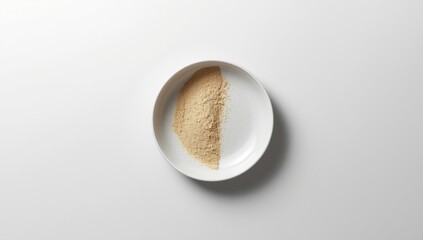 Round dish featuring contrasting powder regions on a white backdrop, highlighting culinary aesthetics