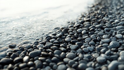 Detailed view of rounded stones along a shoreline featuring dark wet and dry gray pebbles, suitable for editorial header backgrounds, Earth Day