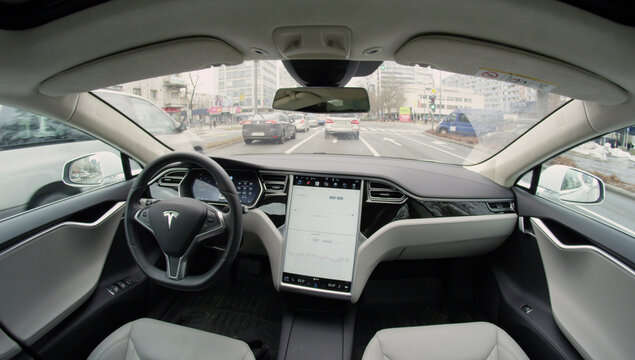 Fully-autonomous self-driving Tesla vehicle navigating a hectic urban landscape