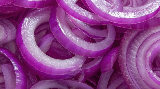 A detailed close-up image of freshly sliced red onion rings, showcasing their vibrant purple color and juicy texture. Perfect for culinary themes, kitchen decor, or health-focused content. - Powered by Adobe