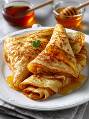Crepes drizzling with honey ready for breakfast