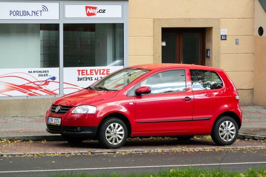 Front side view of red Volkswagen Fox hatchback car parked on street