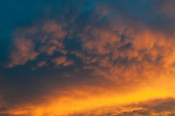 Fototapeta premium Abstract colorful background. Beautiful red sunset over a small town. Dramatic sunset sky with clouds.