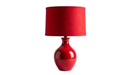 A vibrant, glossy red table lamp with a cylindrical shade, set against a stark black background