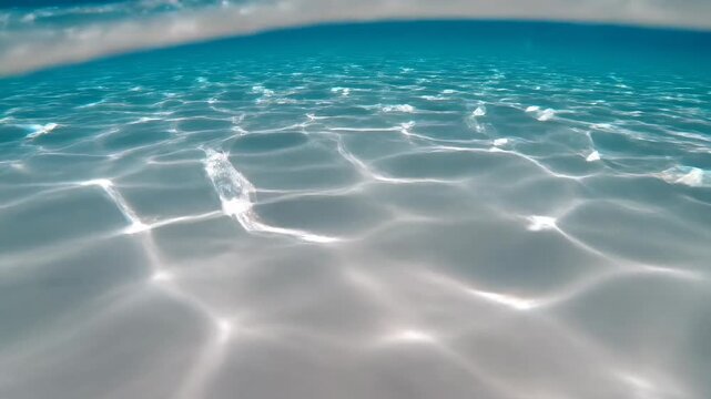 Vivid underwater caustic light patterns rippling and swaying smoothly on a blank surface creating an ethereal and mesmerizing background ocean, organic, blank surface