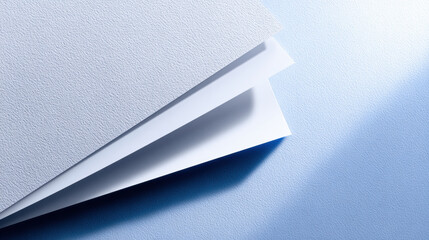 Paper airplane casting soft shadow on textured blue surface, minimal light and calm mood