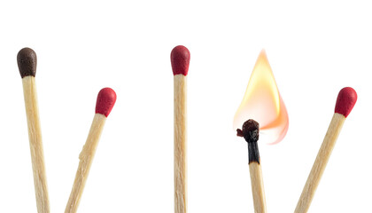 Matchsticks, one ignited with flame, others unlit, arranged against a black background