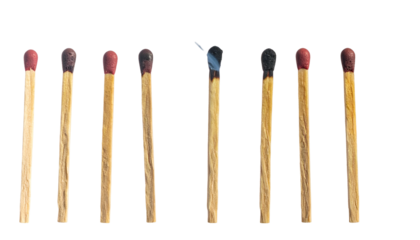 Lineup of matches, some unused, others burnt, showing varying stages of ignition