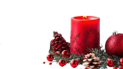 A red candle sits on a table with pine cones and red ornaments