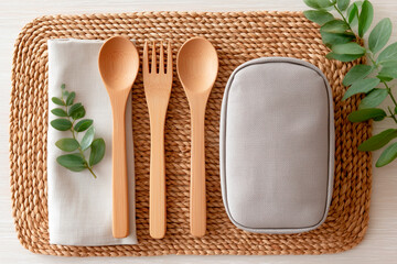 Reusable cutlery and cloth napkin with lunchbox arranged on a table for a simple meal preparation