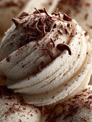 Creamy vanilla ice cream topped with chocolate shavings on a clear background