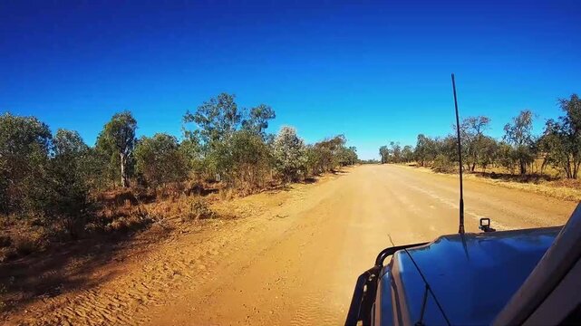 Sunset offroad driving with a 4WD on an Australian outback gravel road
