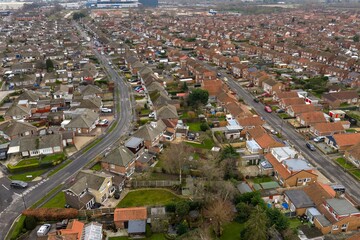 Aerial drone photo of the village of Huntington in the City of York in North Yorkshire England showing rows of typical British houses and housing estates with roads, streets and gardens from above