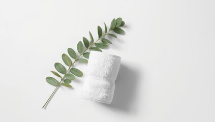 White background featuring a rolled fluffy towel and eucalyptus branch for body care and wellness routines