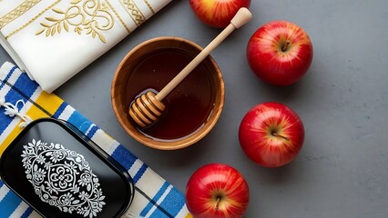 Red apples and honey dipper in wooden bowl on blue table with checkered towels and napkin