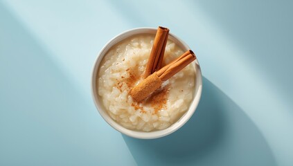 Sweet rice pudding garnished with cinnamon sticks, suitable as a dessert background