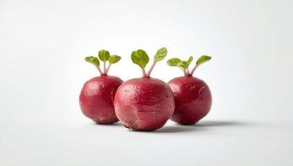 Small red beetroots arranged on white surface, low angle shot emphasizing vibrant hues, ideal for dietary content