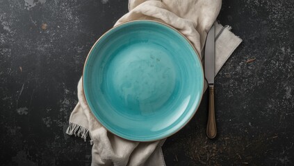 Turquoise plate placed on black stone for visual texture and layout use, World Environment Day